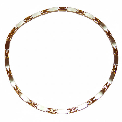 Gold and white chain necklace on a white background