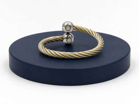 Two-toned bracelet on a dark blue stand with a white background