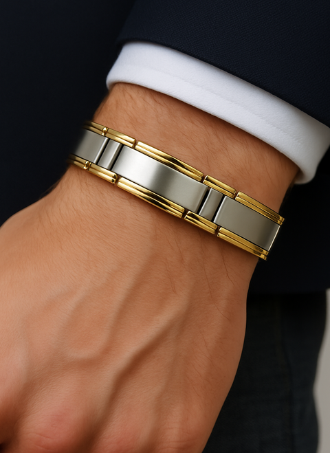 Close-up of a wrist wearing a silver and gold bracelet.