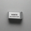 Domino  labeled 'NORTH' on a gray background