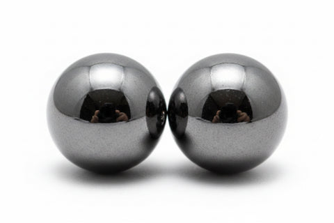Two metallic spheres on a white background