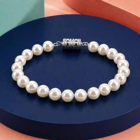 Pearl bracelet with a silver clasp on a blue and orange geometric background