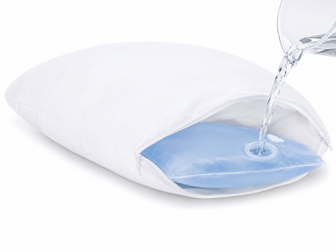 A white inflatable cooling pillow with a transparent opening showing a light blue inner pad, with water being poured into the center from a glass pitcher on a white background.
