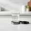 OMI PEMF Medallion with crystal glass of water on marble counter