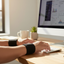 Person working at computer wearing Dr. Sierra magnetic wrist bands